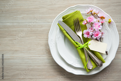 Easter table setting with spring flowers and cutlery