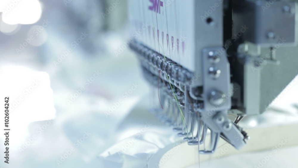 Automatic sewing machine embroider the butterfly colorful pattern on white fabric. Industrial textiles Automatic sewing machine embroider the butterfly colorful pattern on white fabric. Industrial textiles