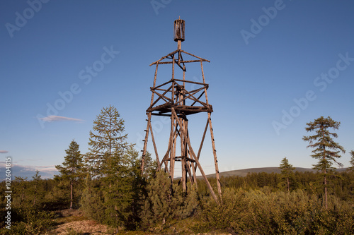 Photography Old wooden triangulation tower in the forest. Yakutia. Russia.