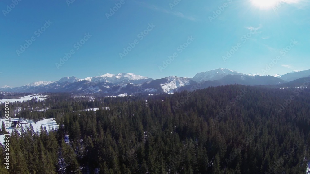 An impressive, aerial, winter view of the high, rocky Tatra mountains (Tatry) which are part of the Carpathians. Steady flight in sunny weather over the green trees and picturesque landscape. An impressive, aerial, winter view of the high, rocky Tatra mountains (Tatry) which are part of the Carpathians. Steady flight in sunny weather over the green trees and picturesque landscape.