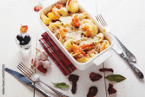 Baked Conchiglioni pasta with srimps, cheese and cream sauce,  traditional Italian cuisine photo