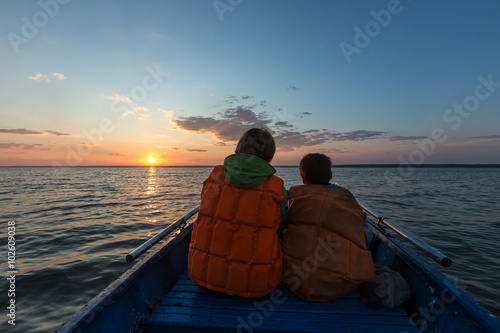 Russia. Novosibirsk. The Ob sea. Mother and son watching the sunset.