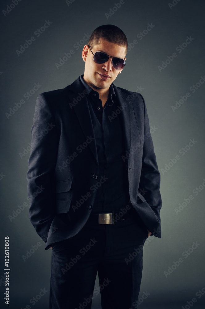 Handsome macho man in suit and sunglasses Handsome macho man in suit and sunglasses