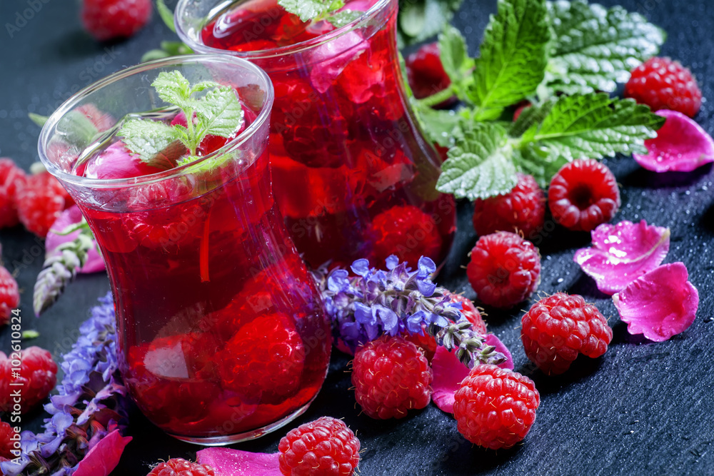 Herbal red tea with raspberries, mint, sage flowers and rose pet Herbal red tea with raspberries, mint, sage flowers and rose pet