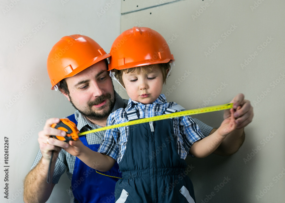 Dad with little son doing repairs Dad with little son doing repairs