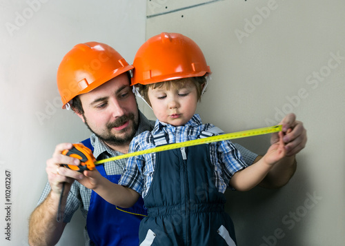 Dad with little son doing repairs