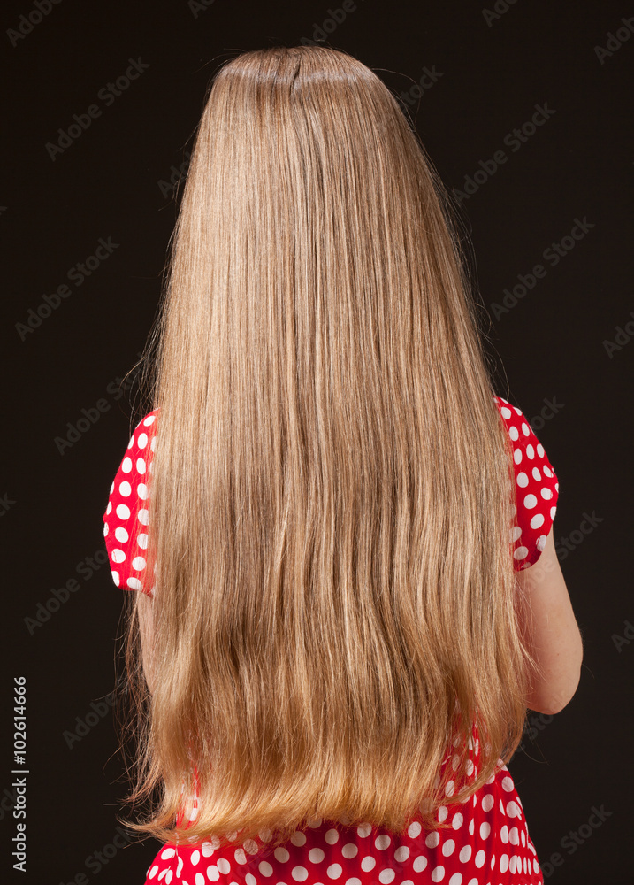 Naklejka premium Unrecognizable portrait of a little girl with beautiful long hai