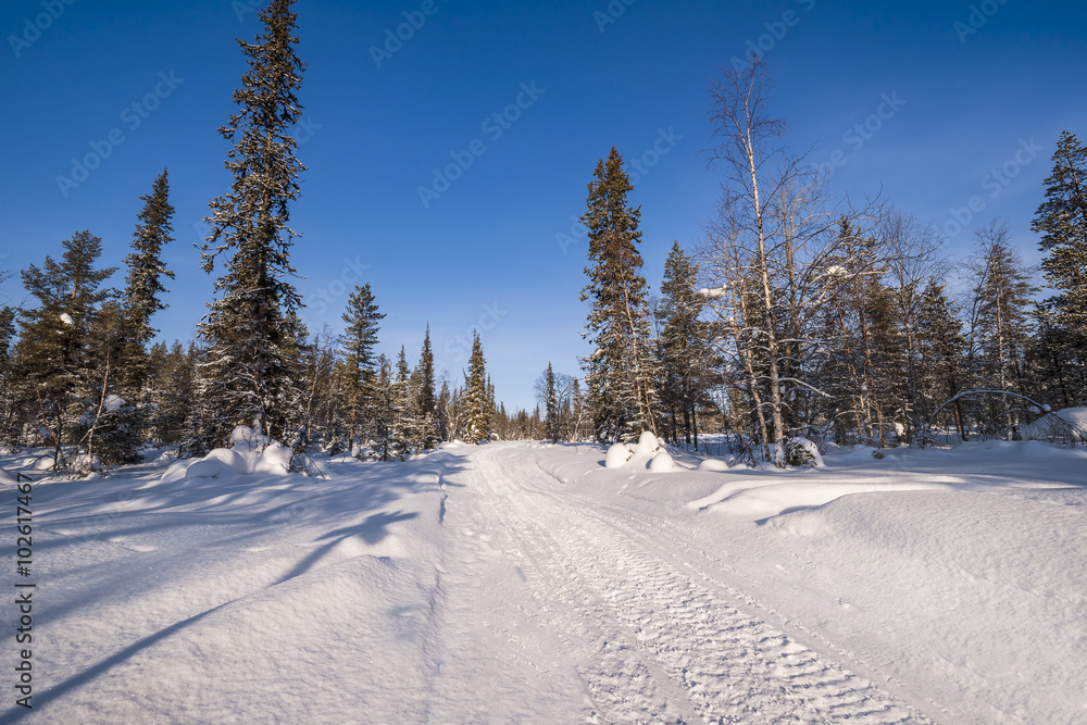 Empty snow covered road in winter landscape Empty snow covered road in winter landscape