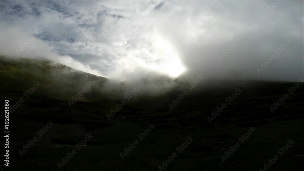 Small clouds slide down the mountain sprouted green grass Small clouds slide down the mountain sprouted green grass