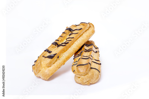 Eclairs with chocolate on white background