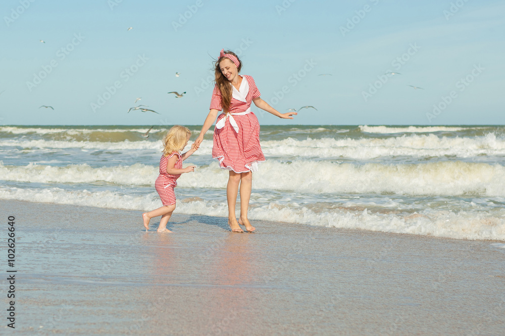 Mother and her daughter having fun on the beach Mother and her daughter having fun on the beach