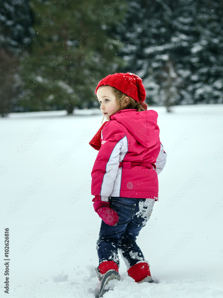 Little girl playing with snow while snowflurry Little girl playing with snow while snowflurry