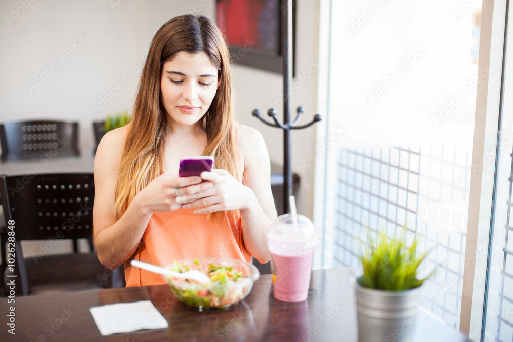 Texting to a friend while eating lunch
