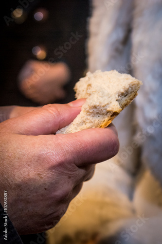 Piece of bread held in the hand while sharing bread