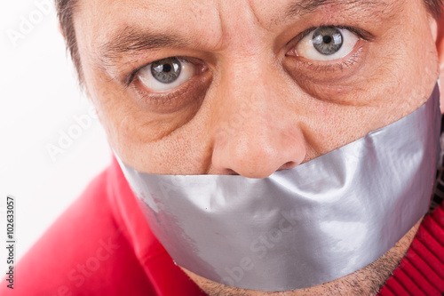 Man with tape gagged mouth photo