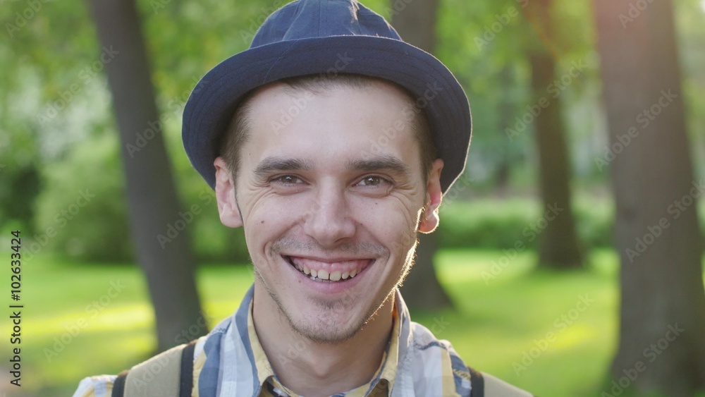 Portrait of boy in hat smile and send air kiss. Summer park Portrait of boy in hat smile and send air kiss. Summer park