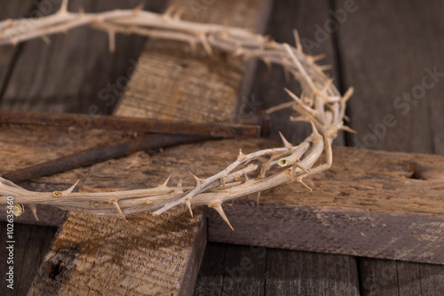Crown of Thorns and Nails on a Rustic Wooden Cross