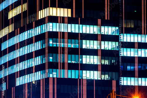 Photography Skyscrapers modern office building with glowing windows at night