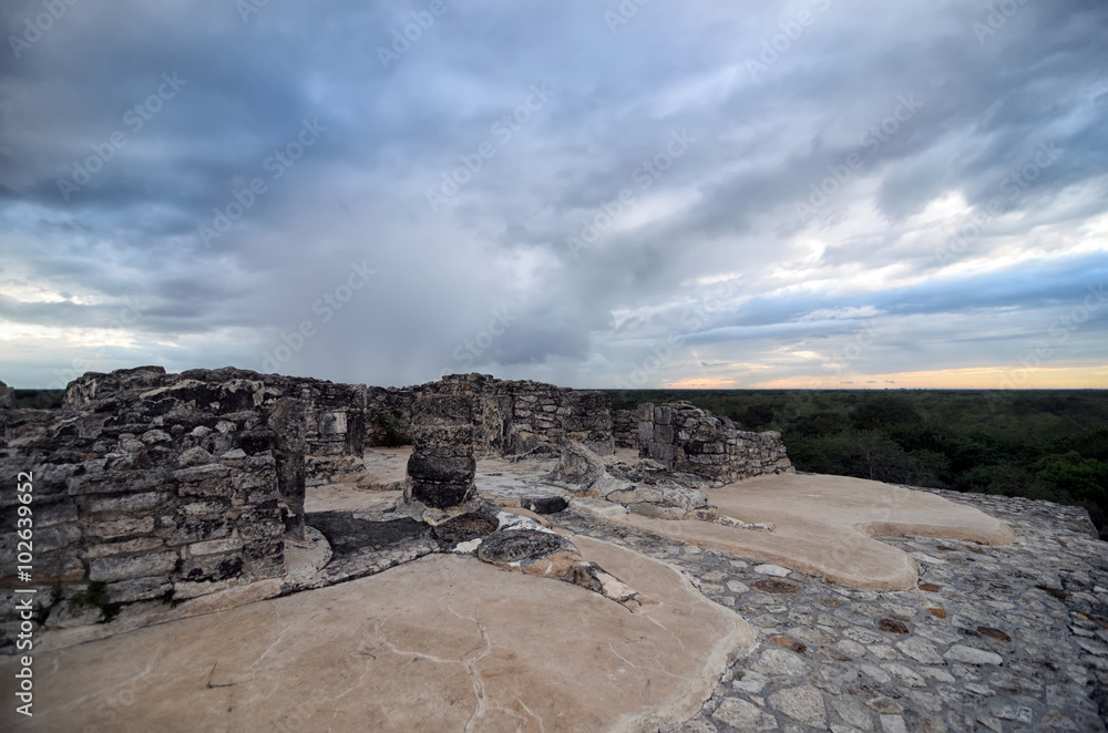 Top of Mayan pyramid under tragic stormy sky 