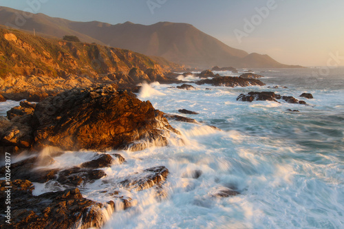 Sunset light and waves crashing on Big Sur coast, central California, United States of America