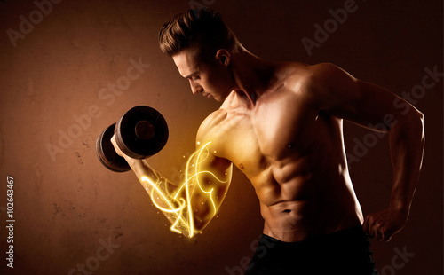 Muscular body builder lifting weight with energy lights on bicep