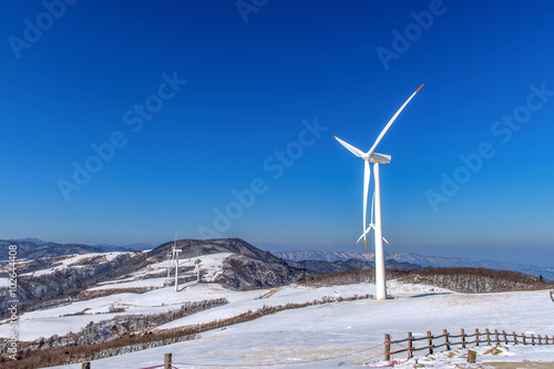 Wind turbine and blue sky in winter landscape. © tawatchai1990