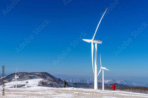 Wind turbine and blue sky in winter landscape. © tawatchai1990