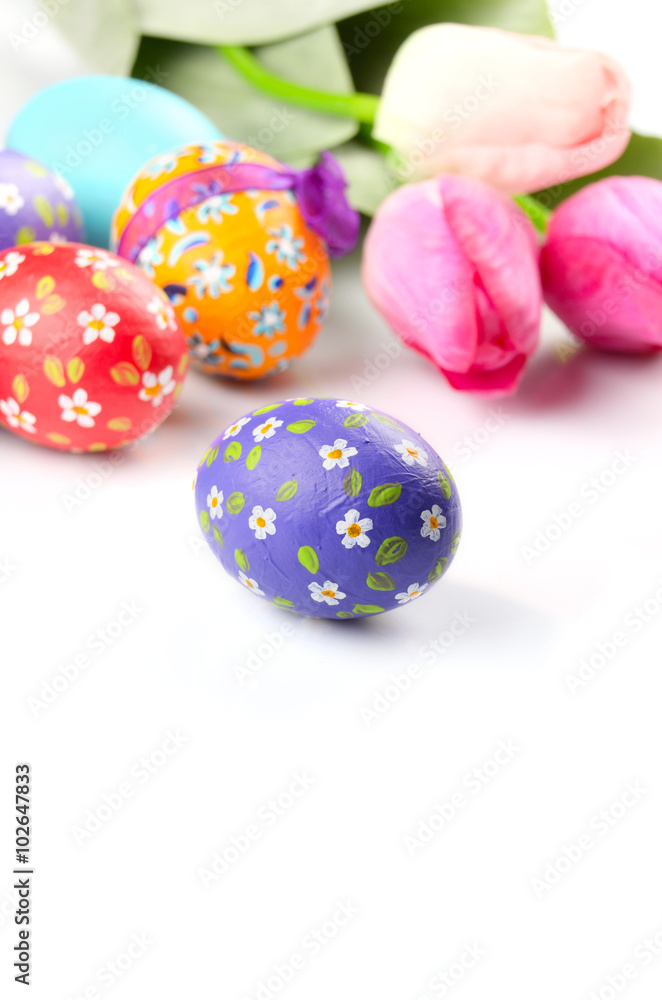 Easter eggs and flowers on white Easter eggs and flowers on white