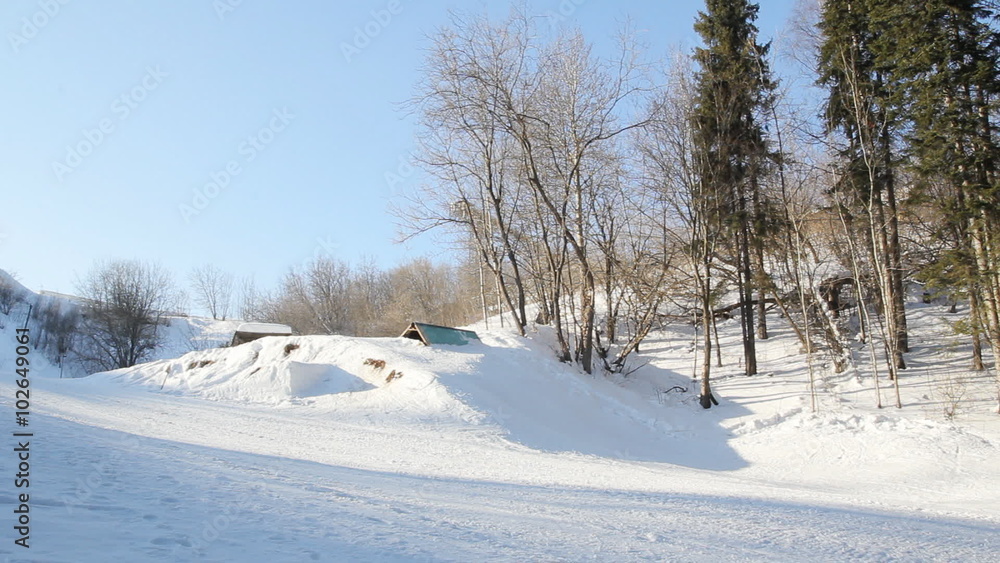 Male snowboarder slides from the mountain in winter day. Male snowboarder slides from the mountain in winter day.