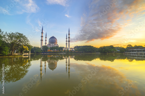 The Beautiful Sultan Salahuddin Abdul Aziz Shah Mosque (also known as the Blue Mosque) with nature sunrise lighting and reflection..