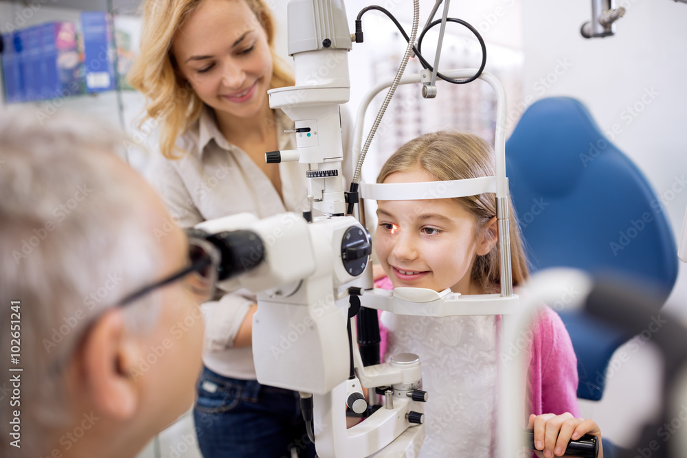 Mother and her daughter talk with eye specialist in clinic Mother and her daughter talk with eye specialist in clinic