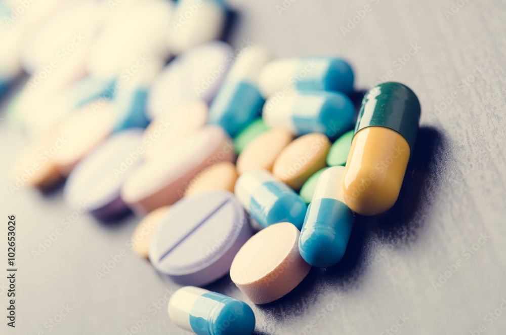 Pharmacy background on a black table. Tablets on a black background. Pills. Medicine and healthy. Close up of capsules. Differend kind of pills Pharmacy background on a black table. Tablets on a black background. Pills. Medicine and healthy. Close up of capsules. Differend kind of pills