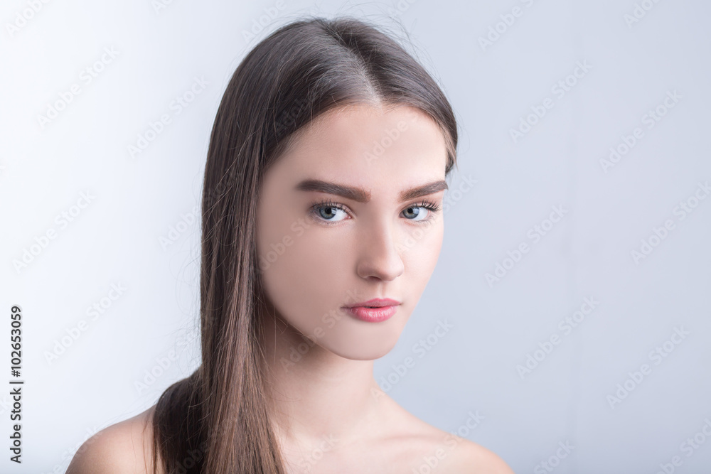 Portrait of beautiful girl with brown hair on white background Portrait of beautiful girl with brown hair on white background