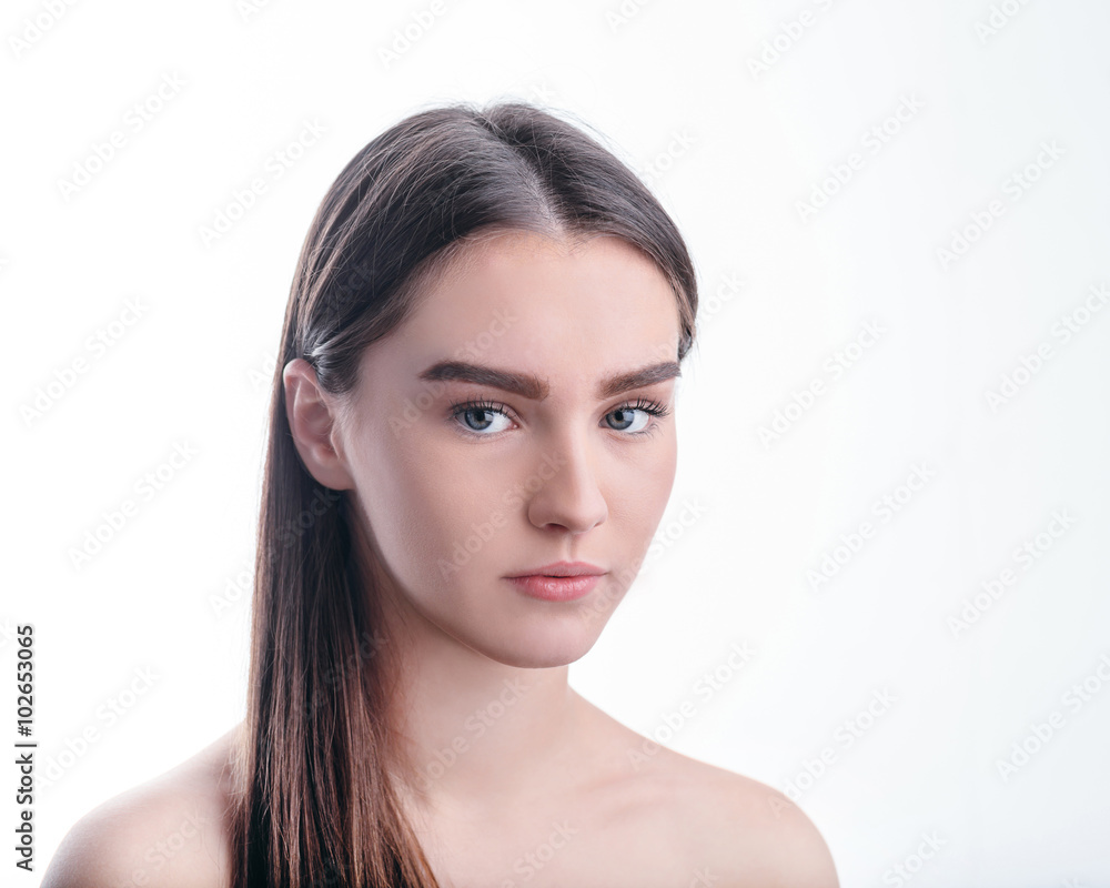 Portrait of beautiful girl with brown hair on white background