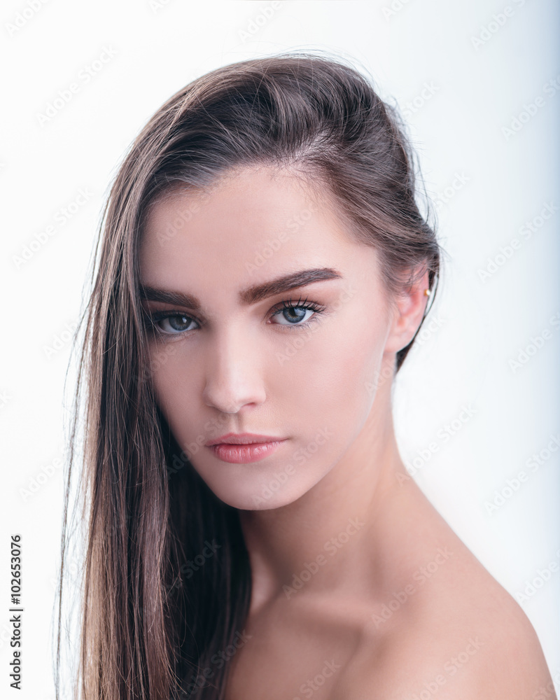 Portrait of beautiful girl with brown hair on white background Portrait of beautiful girl with brown hair on white background