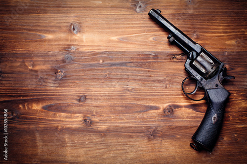 Vintage pistols on wooden background