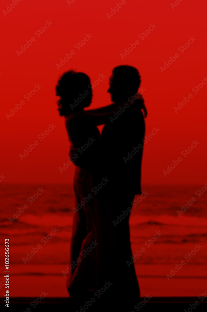 Couple of lover dancing on the beach with red colour, valentine