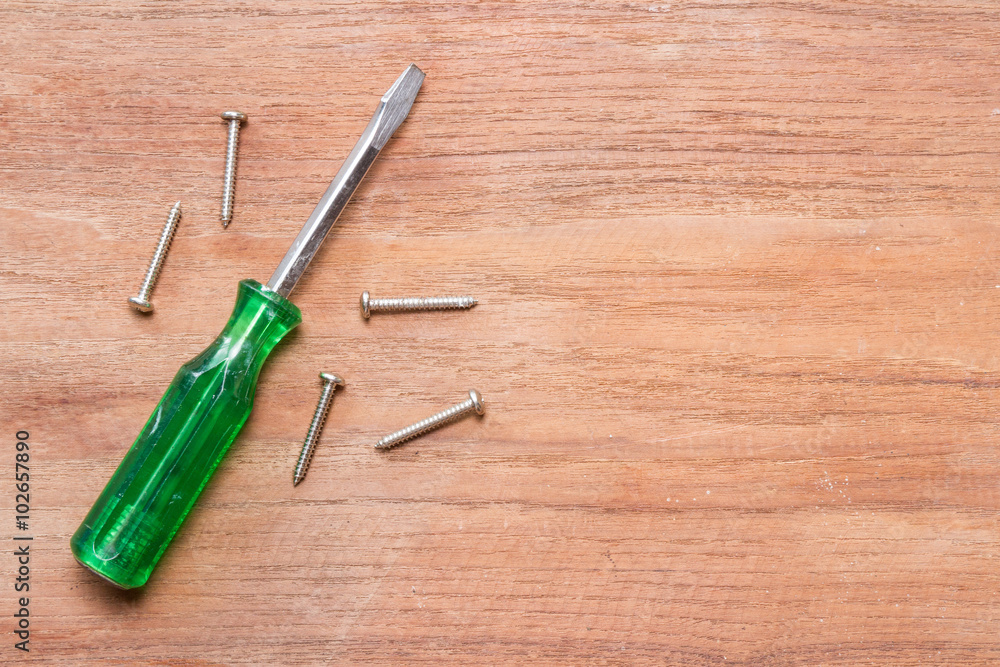 screwdriver on wood background