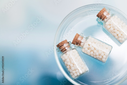 homeopathic pills lying on petri dish in a laboratory photo