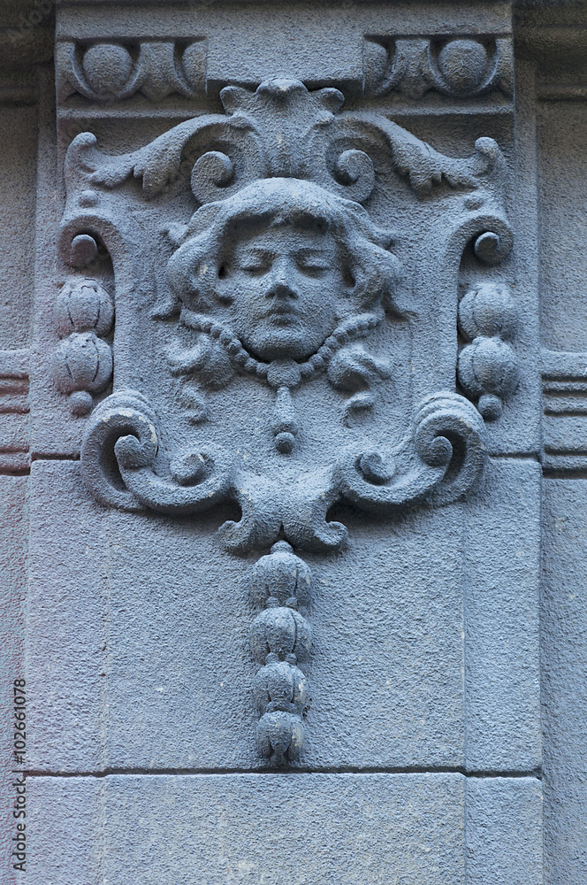 Woman face on the wall. Architecture detail. Stone sculpture. Parged with plaster Woman face on the wall. Architecture detail. Stone sculpture. Parged with plaster
