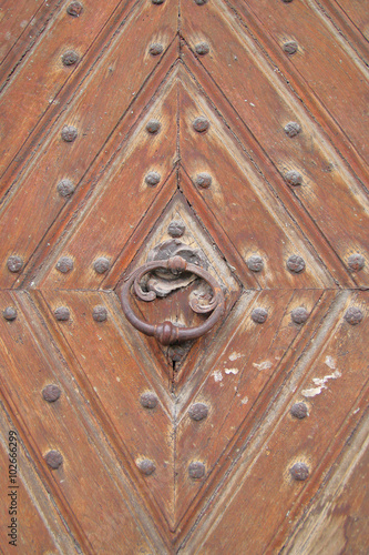 Ancient door with a metal handle.