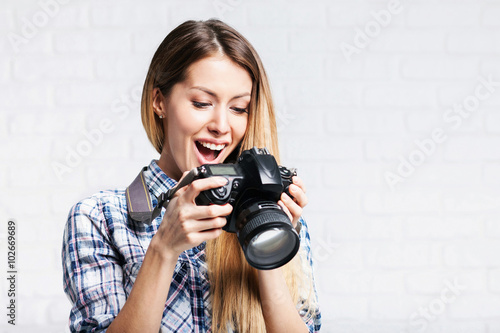 Woman photographer takes images with dslr camera photo