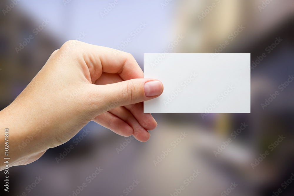 Hands holding a white business visit card, gift, ticket, pass, p Hands holding a white business visit card, gift, ticket, pass, p