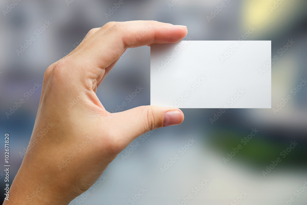 Hands holding a white business visit card, gift, ticket, pass, p Hands holding a white business visit card, gift, ticket, pass, p