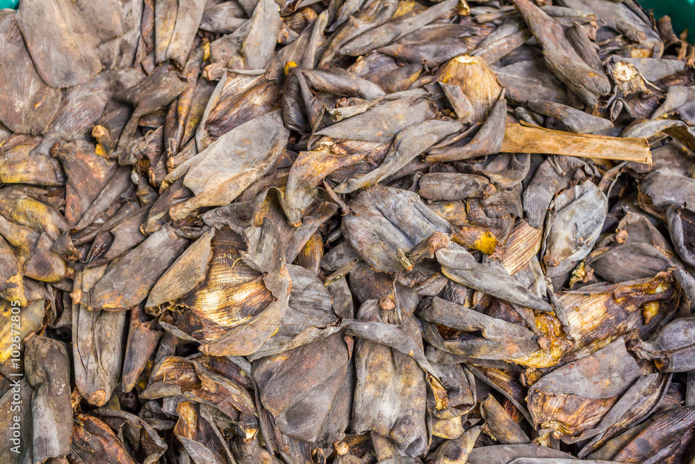 A lot of banana peel on concrete floor - rotten food background.- Close up of black banana peel 
many banana peels in the composter for humus for organic agriculture