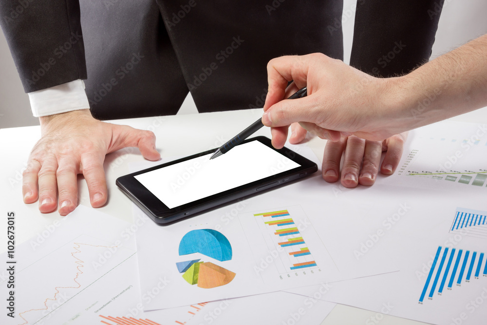 Business people on a meeting analyzing financial reports discuss Business people on a meeting analyzing financial reports discuss