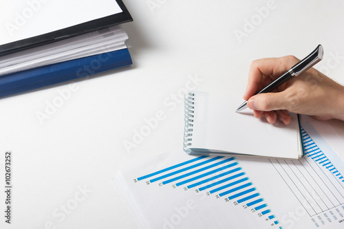 Businessman counting losses and profit working with statistics, analyzing financial the results on white background. Copy space