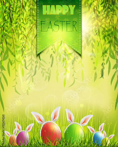 Easter background with eggs in grass and weeping willow.