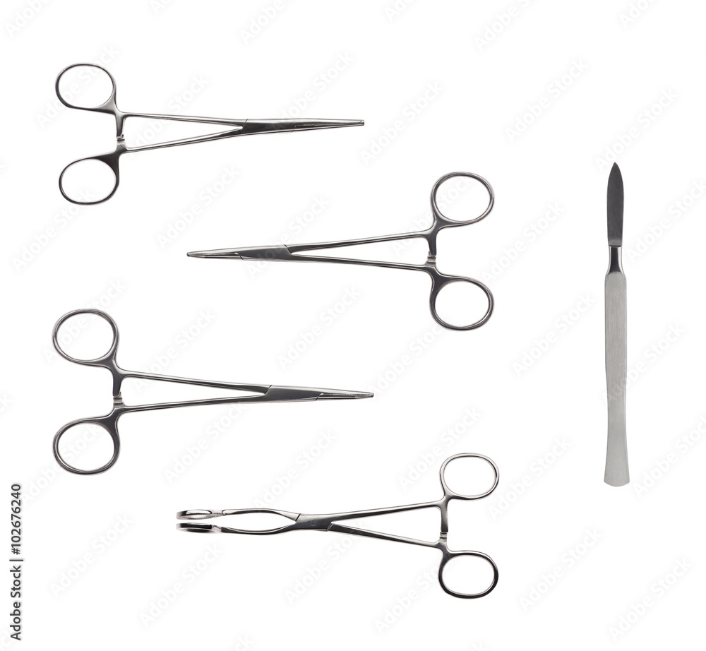 Close up of four stainless steel surgical forceps and scalpel Close up of four stainless steel surgical forceps and scalpel