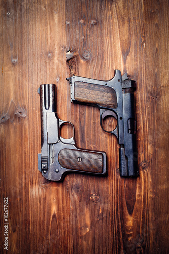 Vintage pistols on wooden background